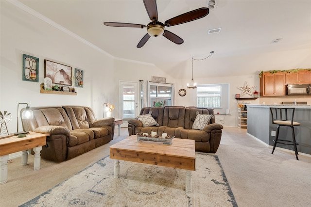 living room featuring crown molding, ceiling fan with notable chandelier, and light colored carpet