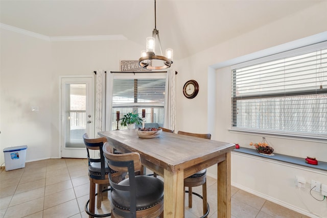 tiled dining room with crown molding, vaulted ceiling, and a chandelier