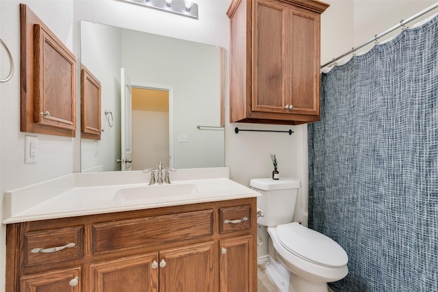 bathroom with vanity, toilet, and walk in shower