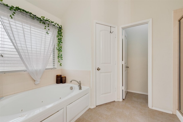 bathroom featuring independent shower and bath and tile patterned flooring