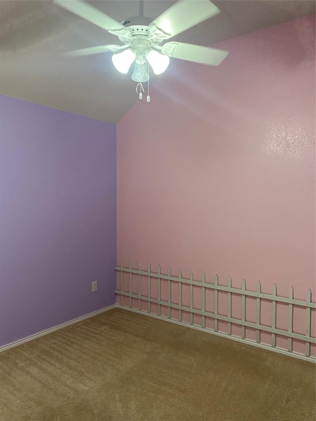 carpeted spare room with ceiling fan and lofted ceiling