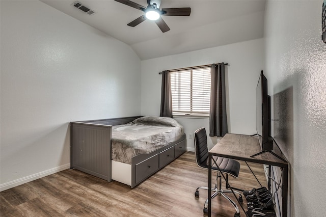 bedroom with lofted ceiling, ceiling fan, and light wood-type flooring