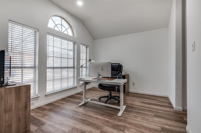 home office with wood-type flooring, lofted ceiling, and a healthy amount of sunlight