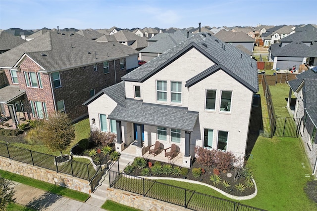 view of property featuring a patio and a front yard