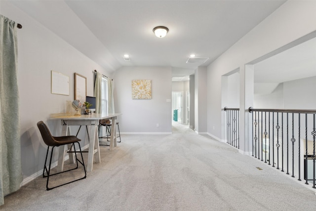 hallway with lofted ceiling and light carpet