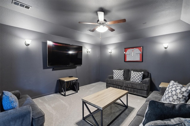 carpeted living room featuring vaulted ceiling and ceiling fan