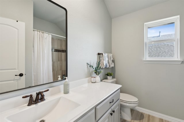 bathroom featuring lofted ceiling, hardwood / wood-style flooring, vanity, toilet, and walk in shower