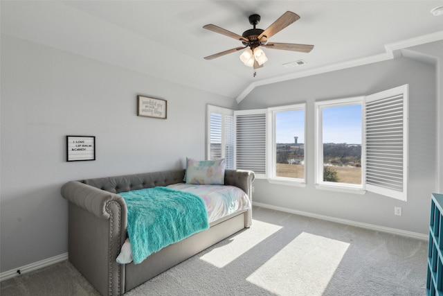 carpeted bedroom featuring vaulted ceiling, ornamental molding, and ceiling fan