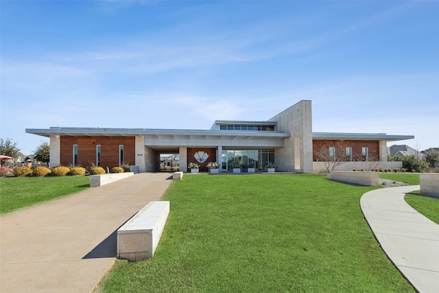 modern home with a carport and a front lawn