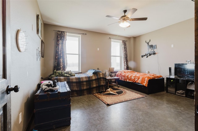 bedroom with concrete floors and ceiling fan