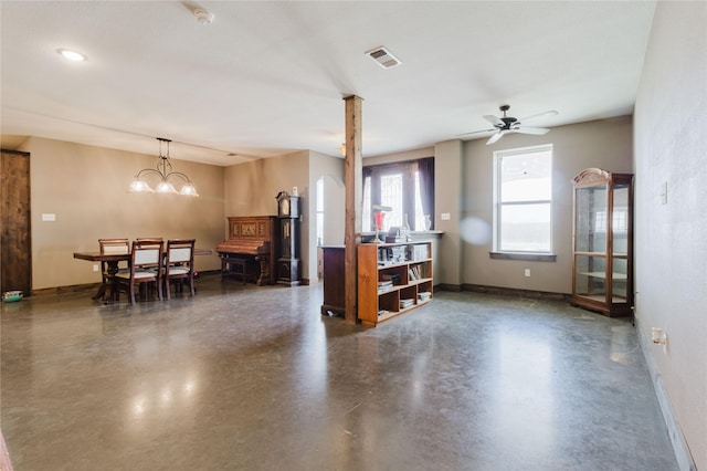 living room featuring baseboards, visible vents, and concrete floors