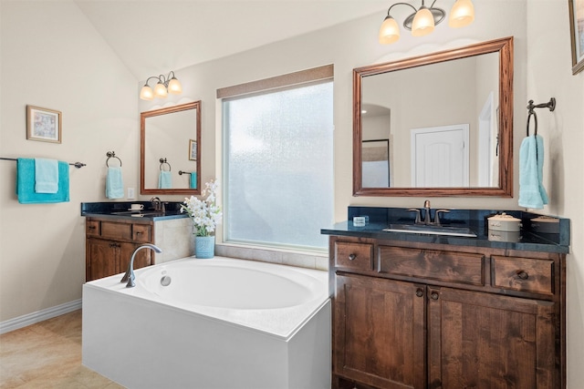 bathroom with lofted ceiling, vanity, a washtub, and tile patterned floors