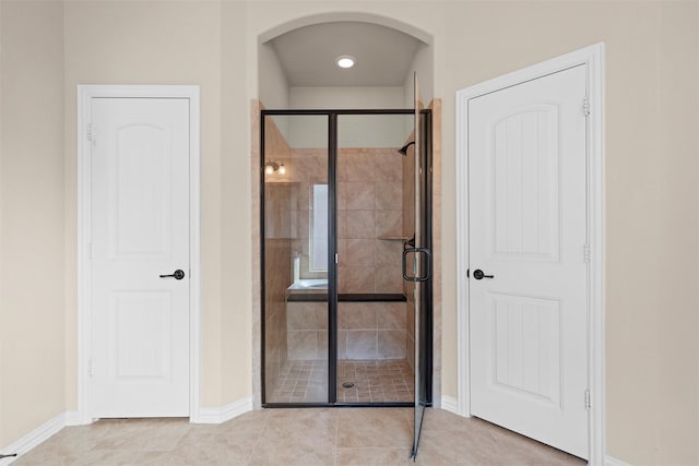 bathroom featuring a shower with door and tile patterned flooring