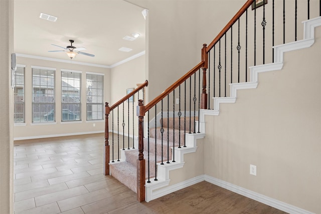 stairway featuring ornamental molding and ceiling fan