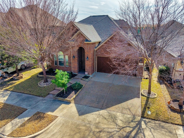 view of front of home with a garage and a front lawn