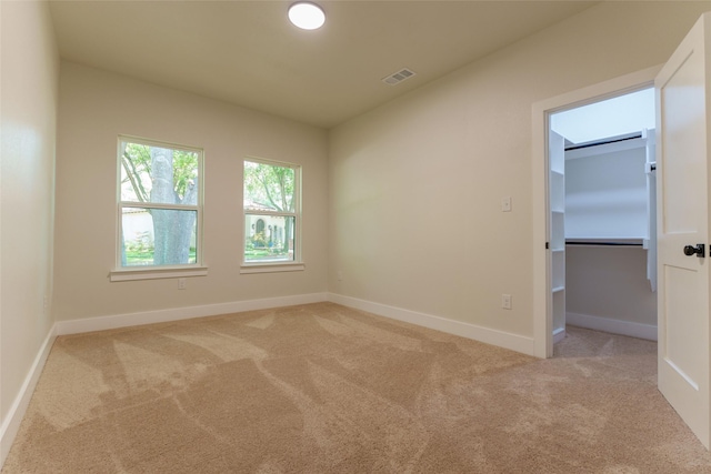 empty room featuring light colored carpet