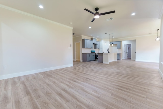 unfurnished living room featuring ornamental molding, sink, ceiling fan, and light hardwood / wood-style floors