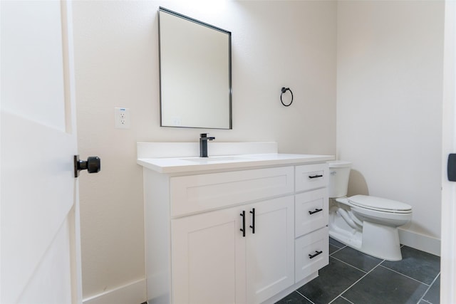 bathroom featuring vanity, tile patterned floors, and toilet