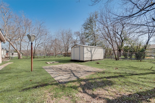 view of yard with an outbuilding, a patio area, a fenced backyard, and a storage unit