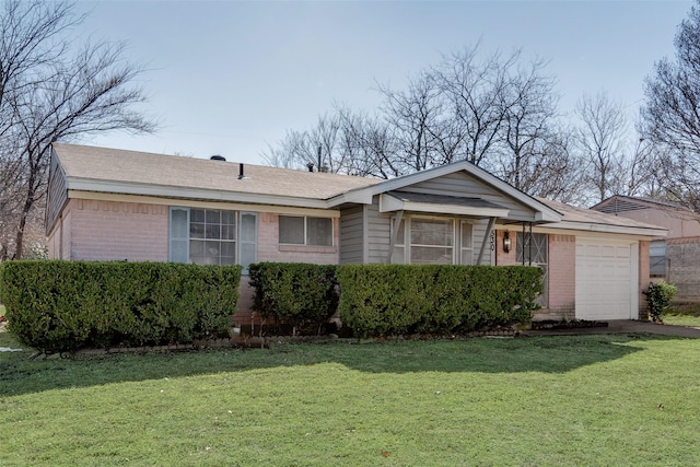 single story home with a garage, a front lawn, and brick siding