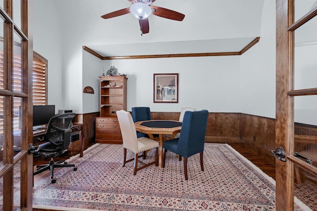 office featuring wooden walls, ornamental molding, and ceiling fan