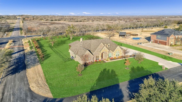 birds eye view of property with a rural view