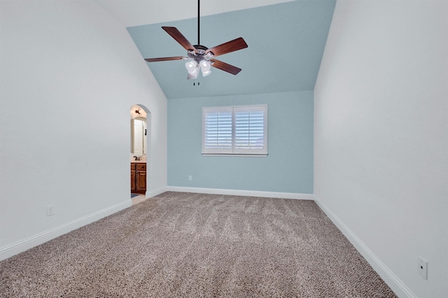 empty room featuring high vaulted ceiling, carpet floors, and ceiling fan