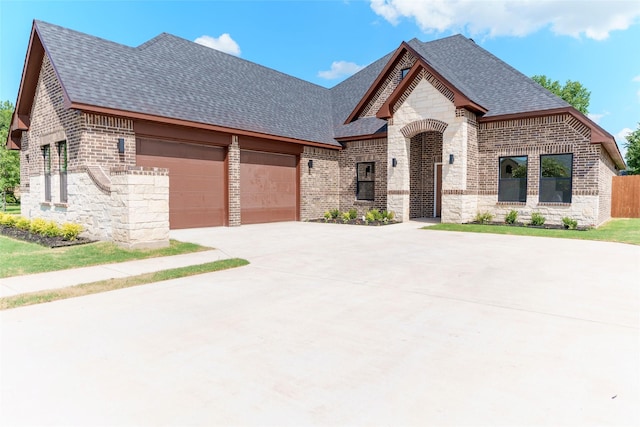 french country home featuring a garage