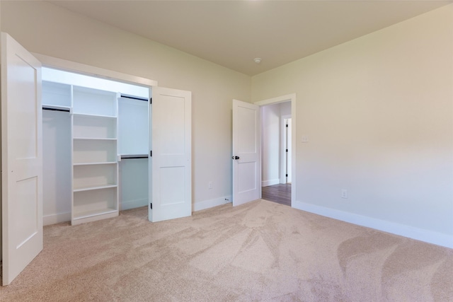 unfurnished bedroom with light colored carpet