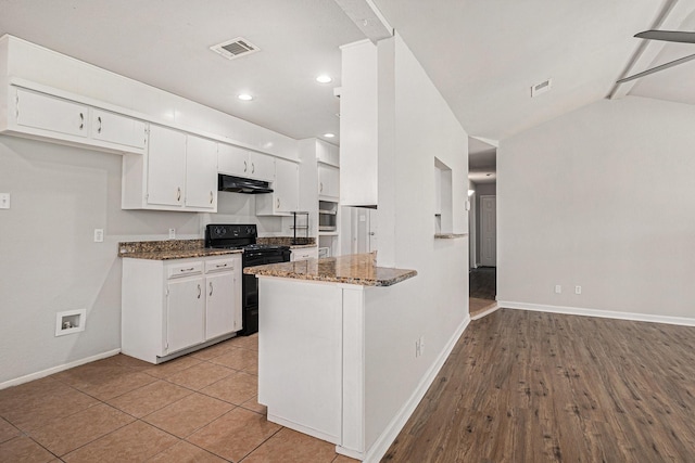 kitchen with lofted ceiling, black electric range oven, white cabinetry, kitchen peninsula, and dark stone counters