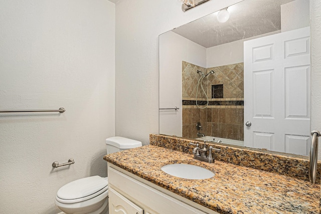 full bathroom featuring vanity, toilet, and tiled shower / bath combo