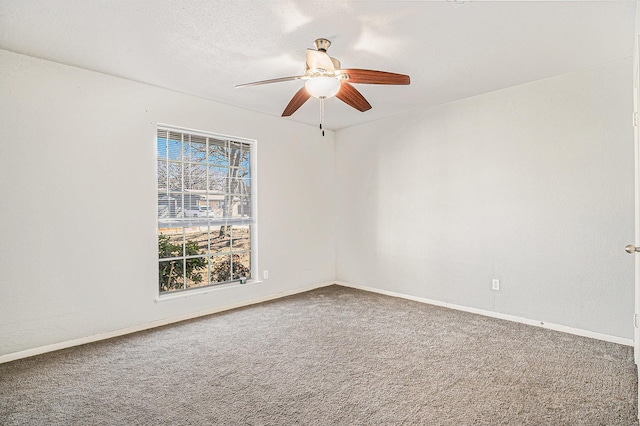 carpeted empty room with a textured ceiling and ceiling fan