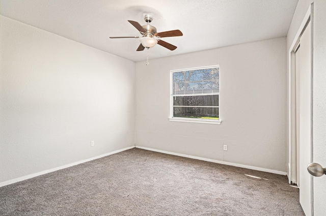 unfurnished bedroom featuring carpet, ceiling fan, and a closet