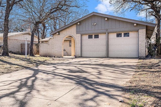 ranch-style house with a garage and an outbuilding