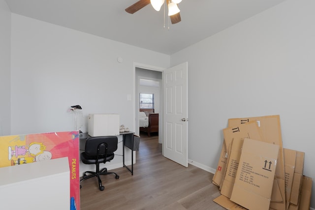 office with light hardwood / wood-style floors and ceiling fan