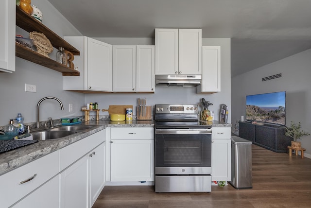 kitchen with electric stove and white cabinets