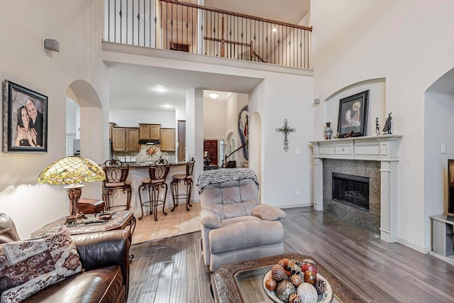 living room featuring a towering ceiling and wood-type flooring