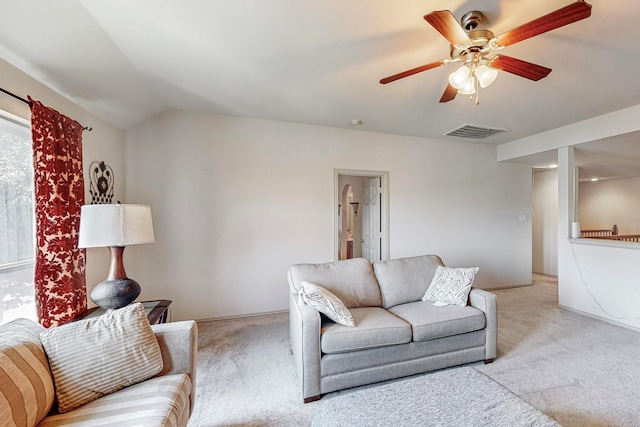 living room featuring vaulted ceiling, light carpet, and ceiling fan