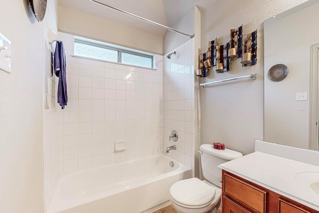 full bathroom with vanity, toilet, and tiled shower / bath combo