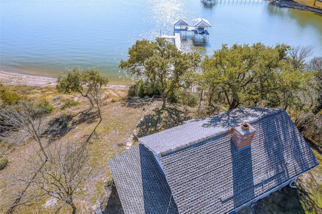 birds eye view of property with a water view and a view of the beach