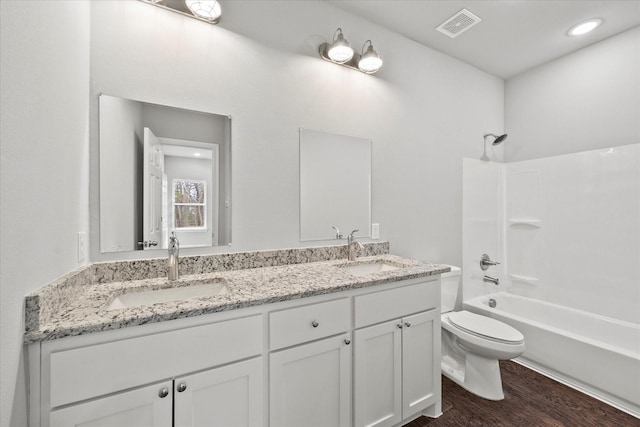 full bathroom featuring vanity, toilet, tub / shower combination, and hardwood / wood-style floors