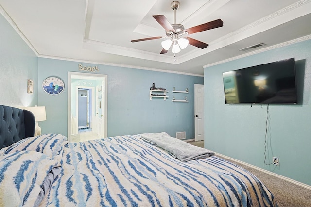 bedroom with a tray ceiling, carpet floors, ornamental molding, and ceiling fan