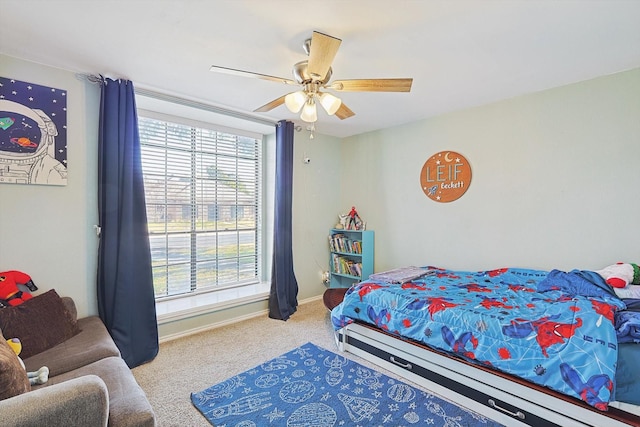 bedroom featuring ceiling fan and carpet