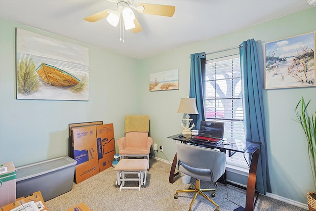 carpeted office featuring ceiling fan