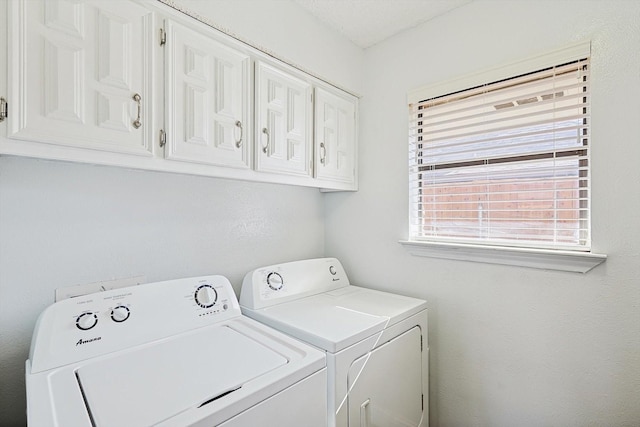 washroom with cabinets and separate washer and dryer