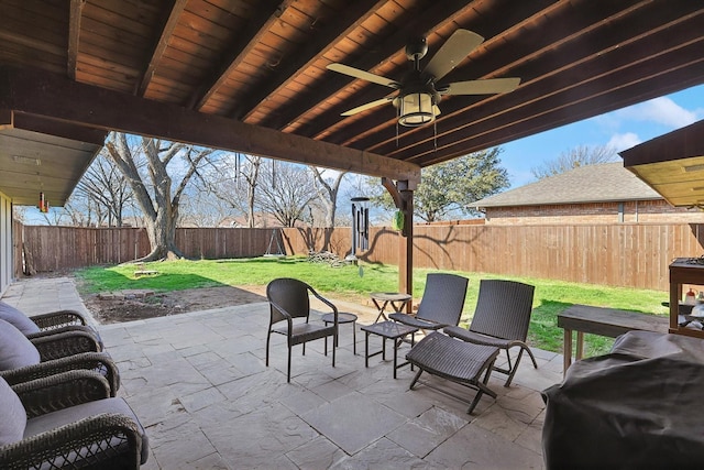 view of patio featuring ceiling fan and a grill