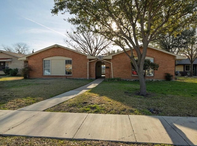 ranch-style home with a front lawn