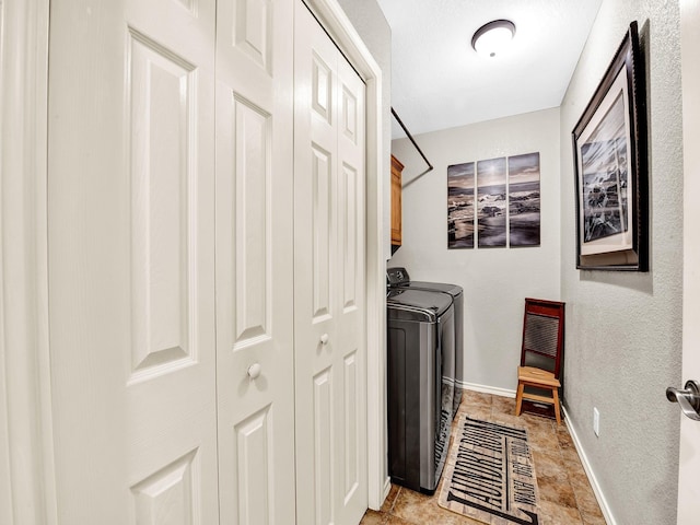 laundry area featuring cabinets and washing machine and clothes dryer