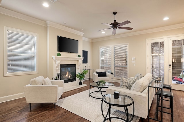 living room with a wealth of natural light, dark hardwood / wood-style floors, and ceiling fan