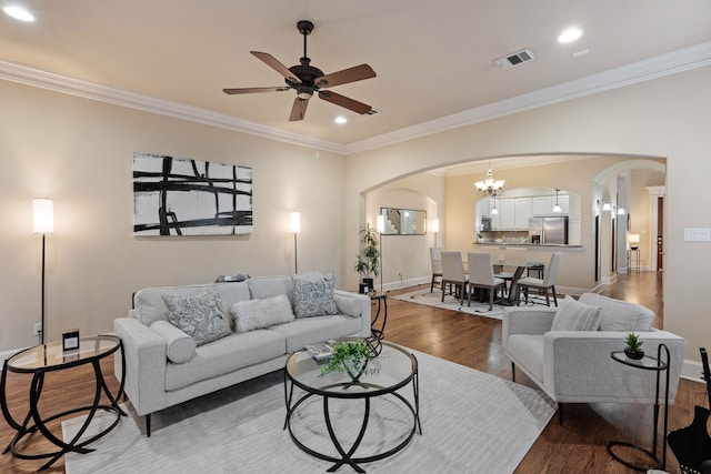 living room with crown molding, ceiling fan, and hardwood / wood-style flooring